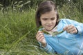 Girl Examining Caterpillar On Leaf