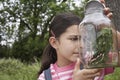 Girl Examining Stick Insects In Jar