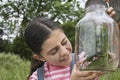 Girl Examining Stick Insects In Jar