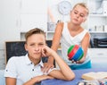 Girl is excusing for the offendedly boy and offering to play ball Royalty Free Stock Photo