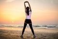 Girl exercising on the beach at sunset Royalty Free Stock Photo