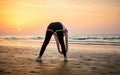 Girl exercising on the beach at sunset Royalty Free Stock Photo