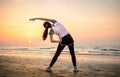 Girl exercising on the beach at sunset Royalty Free Stock Photo