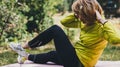 Girl exercising outdoors. Young fit woman doing stretching exercises  training outside in green park. Sport woman play yoga Royalty Free Stock Photo