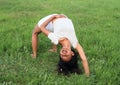 Girl exercising yoga on meadow Royalty Free Stock Photo