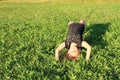 Girl exercising yoga on meadow Royalty Free Stock Photo