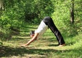 Girl exercising yoga pose downward dog