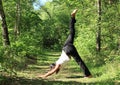 Girl exercising yoga pose three-legged downward dog