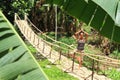 Girl exercising yoga on traditional bridge over river Royalty Free Stock Photo