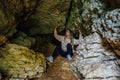 Girl with explores underground limestone cave Royalty Free Stock Photo