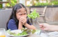 Girl with expression of disgust against vegetables Royalty Free Stock Photo