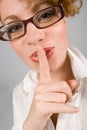 Girl with eyeglasses with finger near lips Royalty Free Stock Photo