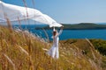 Girl with fabric in hands in the wind Royalty Free Stock Photo