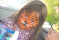 Girl with face painting at Merkinch. Royalty Free Stock Photo