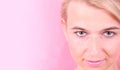 Girl face on a pink background Royalty Free Stock Photo