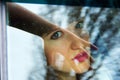 Girl facing through car windows across hand mirroring Royalty Free Stock Photo