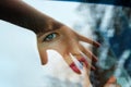 Girl facing through car windows across hand mirroring Royalty Free Stock Photo