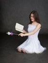 Girl - fairy with magic wand and book in hands