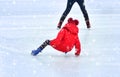 Girl falls on ice at the rink Royalty Free Stock Photo