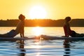 Girl family man woman are doing yoga on a sup Royalty Free Stock Photo