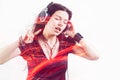 Girl fan sings and dances listening to music. Young brunette woman in big headphones enjoys music Royalty Free Stock Photo