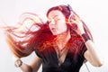 Girl fan sings and dances listening to music. Young brunette woman in big headphones enjoys music Royalty Free Stock Photo