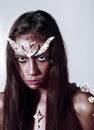 Girl fantasy style makeup. Halloween ideas concept. Woman with horns and thorns fantasy creature. Diabolic appearance