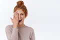 Girl fascinated how good her nails done. Attractive sassy redhead woman with curly combed hair, cover one side of face