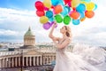 Girl, fashion model with balloons in a waved dress on the background of St. Petersburg, Russia. Kazan Cathedral