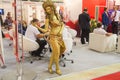 Girl fashion model depicts a sculpture of metal in the international exhibition industry