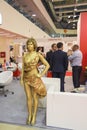 Girl fashion model depicts a sculpture of metal in the international exhibition industry