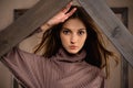 Girl fashion portrait in the studio on a background of wooden scenery