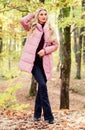 Girl fashionable blonde walk in autumn forest. Jackets everyone should have. Best puffer coats to buy. How to rock