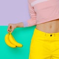 Girl in fashionable clothes holding Bananas. Vanilla summer style Royalty Free Stock Photo