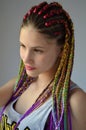 A girl with a fashionable set of multicolored braids Kanekalon. Colored artificial strands of hair. Royalty Free Stock Photo