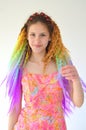 A girl with a fashionable set of multicolored braids Kanekalon. Colored artificial strands of hair.