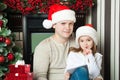 Girl and father in hats write letter to Santa