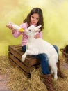 Girl feeding baby goat Royalty Free Stock Photo