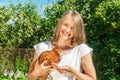 Girl feeding brown chicken