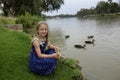 Happy Young Girl Feeding Ducks By The Murray River Royalty Free Stock Photo