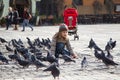 Girl feeding pigeons