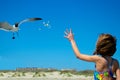 Young Girl Feeding a Seagull