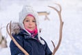 Girl feeding reindeer in the winter Royalty Free Stock Photo