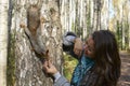 Girl feeding squirrel in autumn park, close-up Royalty Free Stock Photo