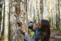 Girl feeding squirrel in autumn park, close-up Royalty Free Stock Photo