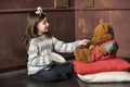 Girl feeding a teddy bear Royalty Free Stock Photo