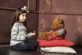 Girl feeding a teddy bear Royalty Free Stock Photo