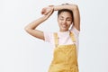 Girl feeling great after meditation. Portrait of calm and relaxed feminine dark-skinned woman in stylish yellow