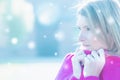 Girl feels cold outside.Portrait of frozen white blonde female in knit pink sweater.Young woman snuggles warm in her
