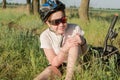 The girl fell off her bike and hit her knee. Girl cyclist holding her knee Royalty Free Stock Photo